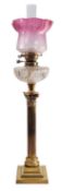 A late Victorian or Edwardian brass and glass mounted columnar table oil lamp,