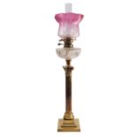 A late Victorian or Edwardian brass and glass mounted columnar table oil lamp,