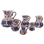 A mixed lot comprising a graduated set of four reproduction Mason's-style Ironstone Hydra jugs,