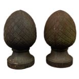 A pair of cast iron pier finials, 20th century; of ovoid form and cast with curved cross-hatching,