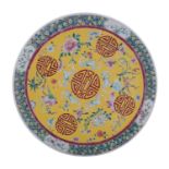 A Chinese yellow-ground famille rose charger painted with shou characters, bats,