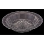 A large early 19th century cut-glass bowl of stepped and fluted form with star-cut base,