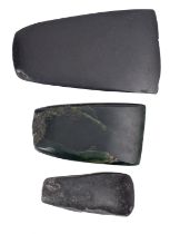 Three polished stone axe heads, possibly Neolithic, the largest 13cm high, 7.