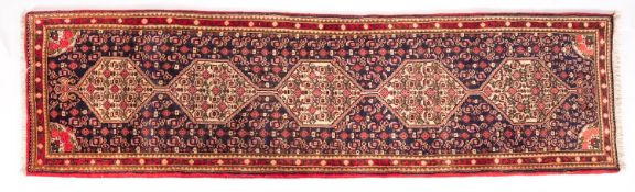A Senneh runner, the shaded field with a row of five ivory hexagonal medallions,