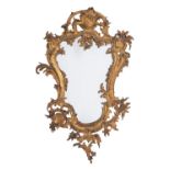 A gilt metal framed wall mirror in Rococo style, second half 19th century; of cartouche form,