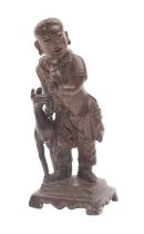 A Chinese bronze figure of a boy holding a parrot, a gourd on his back and a faun at his side,