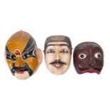 Three Oriental masks, comprising two Indonesian carved wooden Topeng dance masks of King Dalem,