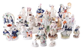A group of approximately twenty Staffordshire pottery figures, animals, spill vases,