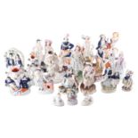 A group of approximately twenty Staffordshire pottery figures, animals, spill vases,