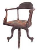 A Victorian carved and stained mahogany and later seat upholstered swivel desk chair,