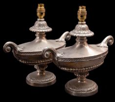 A pair of silver plated metal twin-handled urns fitted as table lamps,
