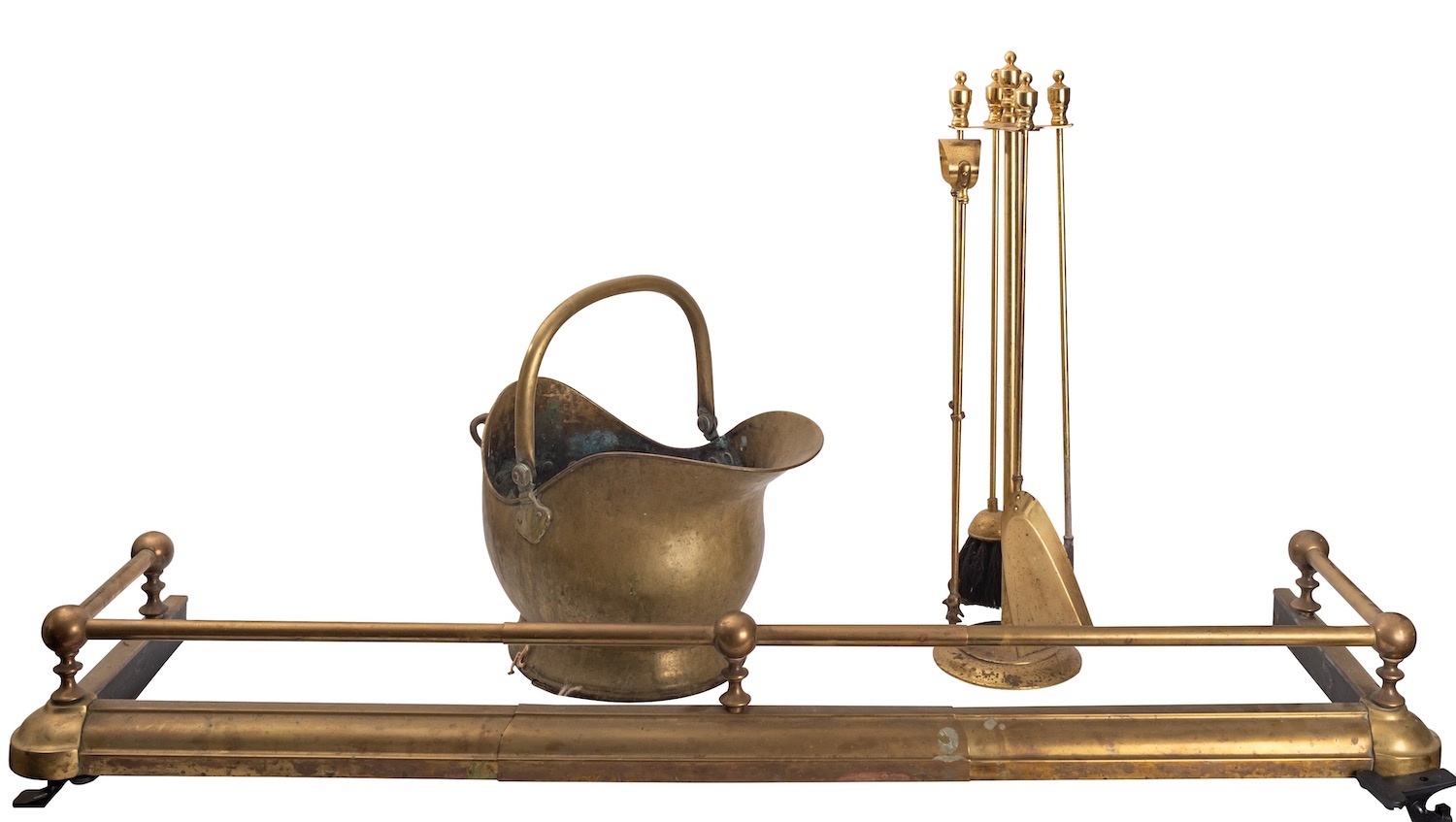 An associated suite of brass fireplace furniture, comprising a fender in 19th century style,