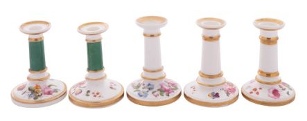 A pair of Coalport miniature tapersticks and three similar all painted with flower sprays and gilt