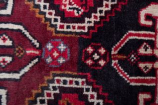 A Qashgai carpet, the rose field with triple hexagonal stepped central medallions,