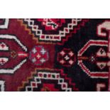 A Qashgai carpet, the rose field with triple hexagonal stepped central medallions,