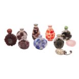 A group of seven Chinese overlay glass snuff bottles in blue, aubergine, green and red overlay,