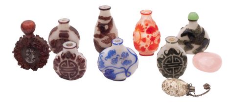 A group of seven Chinese overlay glass snuff bottles in blue, aubergine, green and red overlay,