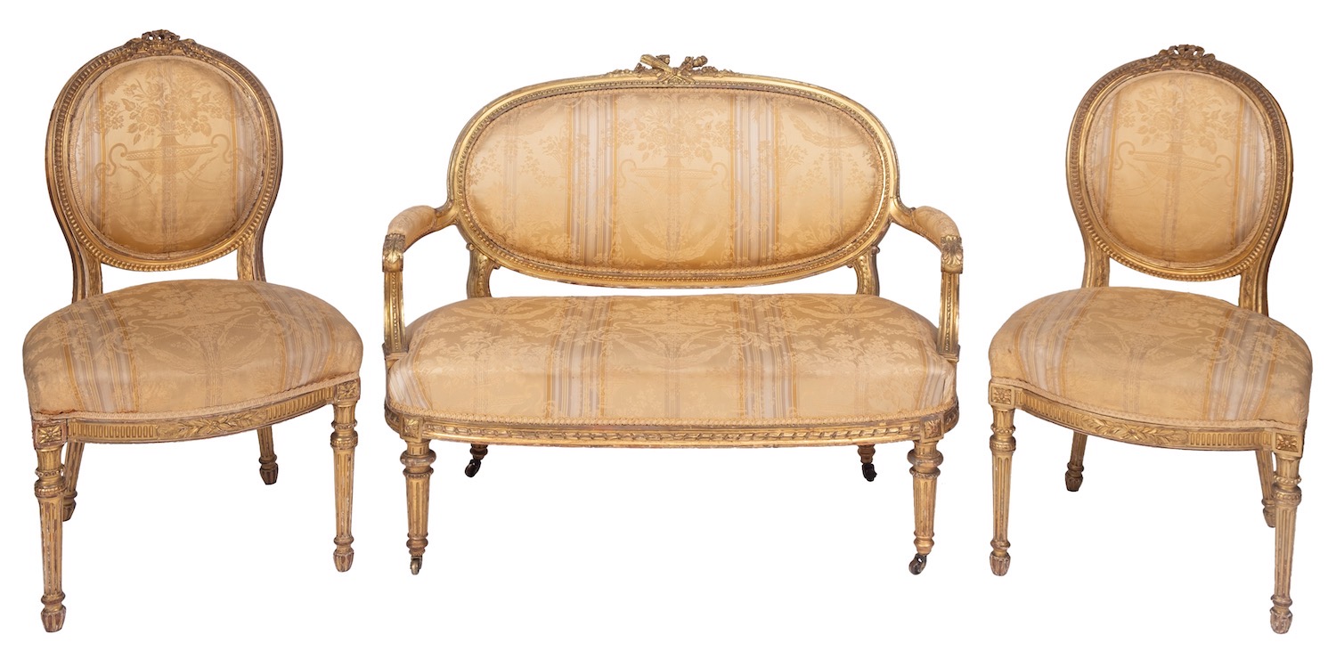 A carved giltwood and Damask fabric upholstered associated salon suite in Louis XVI style,
