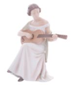 A Bing & Grondahl porcelain figure, Woman with Guitar, modelled after the original by Irminger,