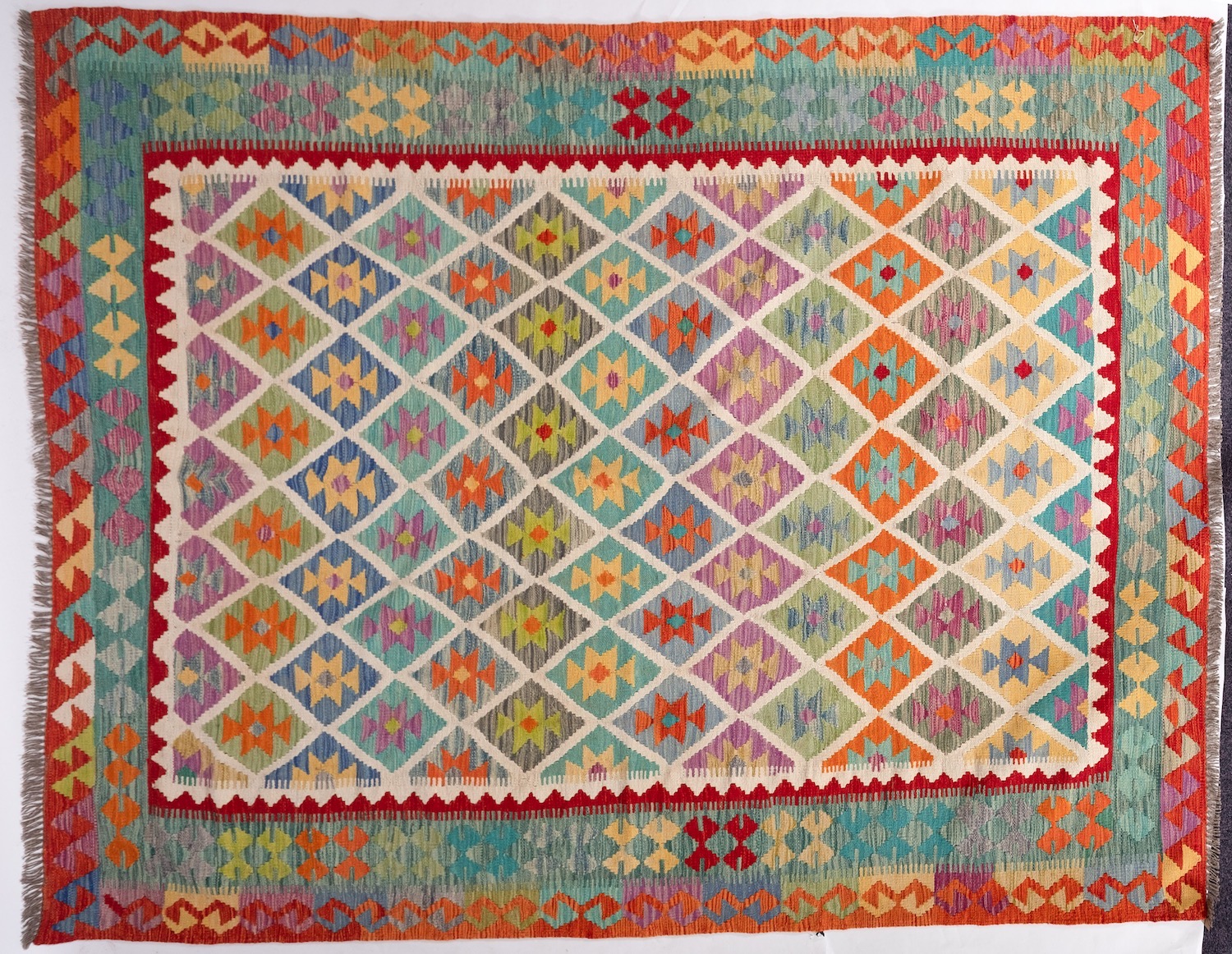 An Anatolian Turkish Kilim, the brightly coloured lozenge field in a variety of pastel shades, - Image 2 of 2