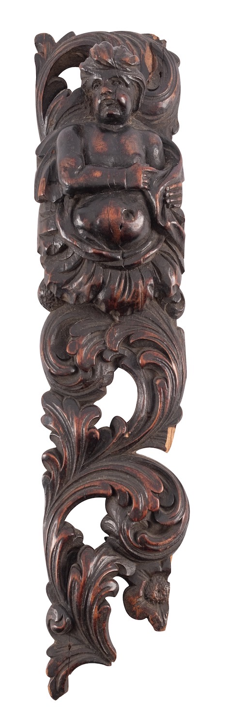 A carved and stained walnut herm, early 17th century; relief carved with a torso length male figure,