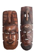 Two African carved hardwood and bone inset masks,