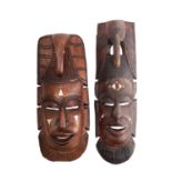 Two African carved hardwood and bone inset masks,