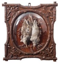 A pair of 'Black Forest' carved and stained oak framed game trophies, Dutch,