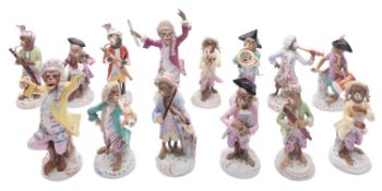 An assembled collection of twelve Continental porcelain monkey band musicians and two conductors