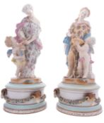 A pair of French porcelain figure groups and stands in the form of classical female figures