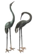 A pair of large patinated metal garden models of cranes, modern; naturalistically cast standing,