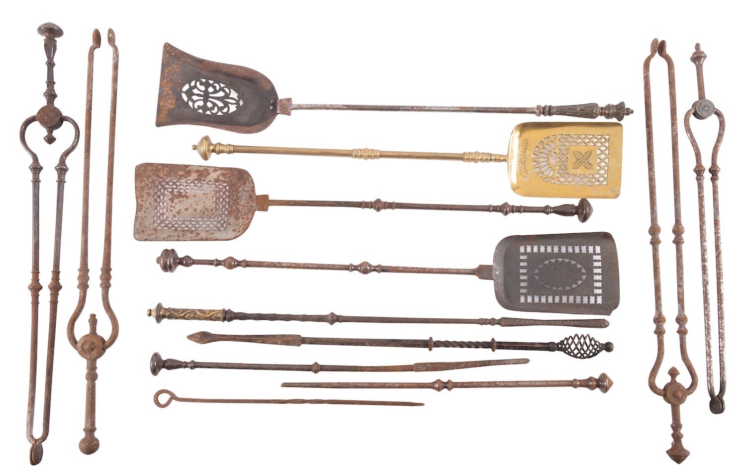 A group of steel and brass mounted fire irons,