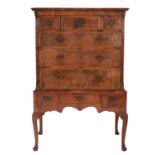 A George II walnut and feather banded chest on stand,