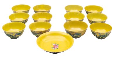 Twelve Chinese porcelain bowls, each decorated with opposing dragons on a yellow ground,