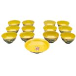Twelve Chinese porcelain bowls, each decorated with opposing dragons on a yellow ground,