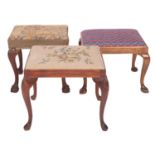 Two carved mahogany and upholstered dressing table stools in George II style,