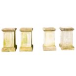 A set of four stone composition garden plinths, 20th century; of square section,