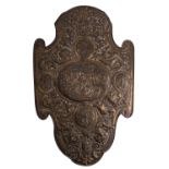 A Continental repoussé worked brass and pine backed model of a shield,