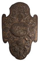 A Continental repoussé worked brass and pine backed model of a shield,