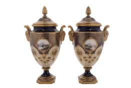 A pair of Coalport porcelain vases and covers with ram's-head handles and pineapple finials,