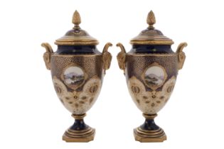 A pair of Coalport porcelain vases and covers with ram's-head handles and pineapple finials,