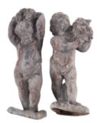 A pair of lead models of putti,
