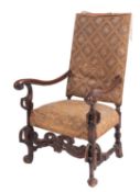 A carved walnut and embroidery upholstered elbow chair in Spanish late 17th century style,