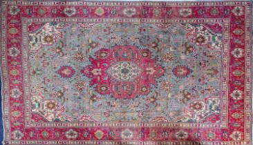 A Heriz carpet, the pastel blue field with a central rose geometric pole medallion,