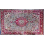 A Heriz carpet, the pastel blue field with a central rose geometric pole medallion,