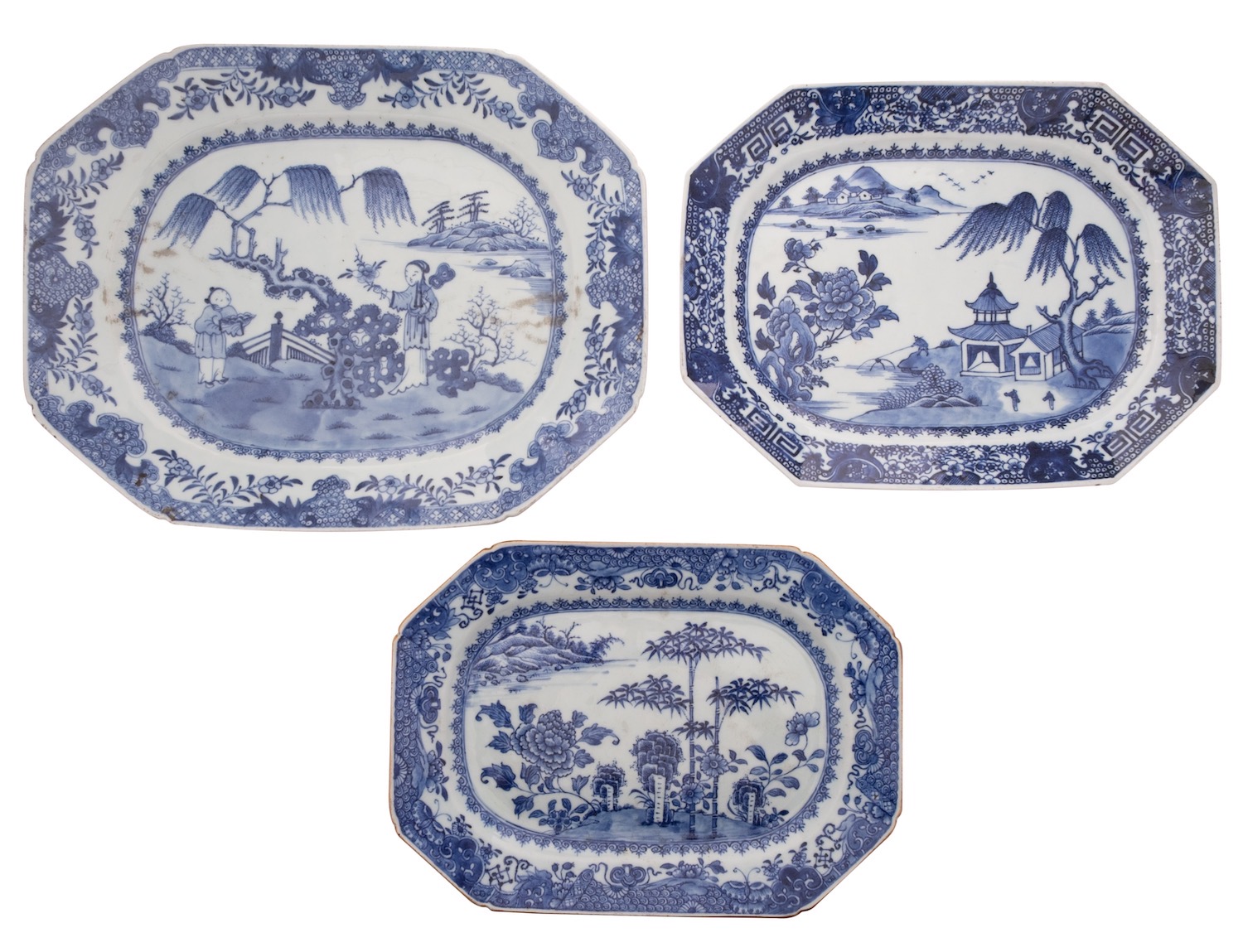 A group of three Chinese blue and white octagonal dishes two painted with lake landscapes,