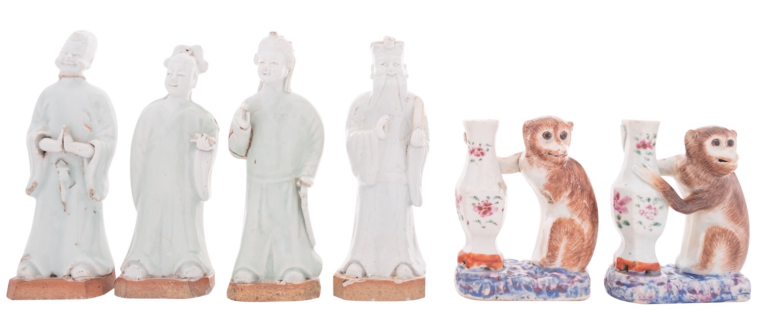 Two Chinese famille rose monkey candlesticks and four celadon glazed figures of Immortals,