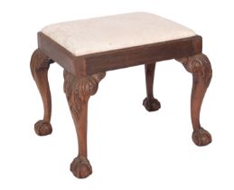 A carved mahogany and upholstered dressing table stool in late George II style,