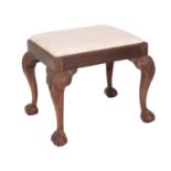 A carved mahogany and upholstered dressing table stool in late George II style,