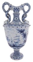A large Dutch Delft pedestal vase with entwined serpent handles terminating in grotesque masks,
